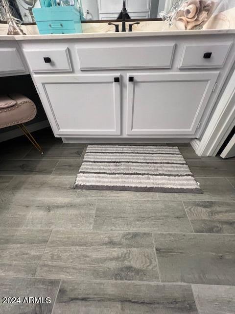 19014 N 91st Dr, Peoria, AZ 85382 - detailed view of white cabinets, wood finished floors, and light countertops