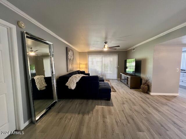 19014 N 91st Dr, Peoria, AZ 85382 - living area with ceiling fan, wood finished floors, baseboards, and ornamental molding