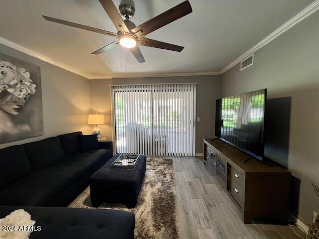 19014 N 91st Dr, Peoria, AZ 85382 - living room with ceiling fan, light wood finished floors, crown molding, and baseboards