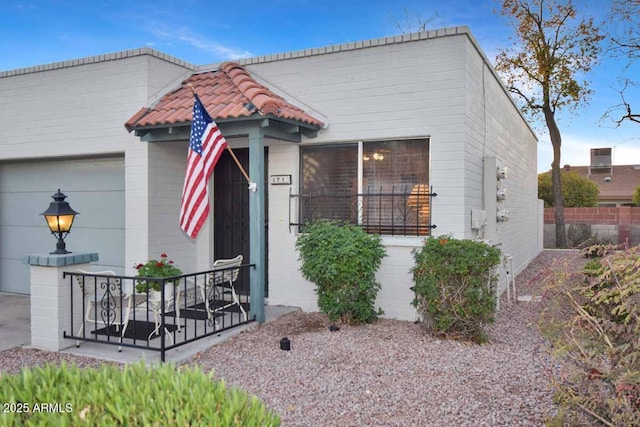 view of front of property with a tile roof and fence