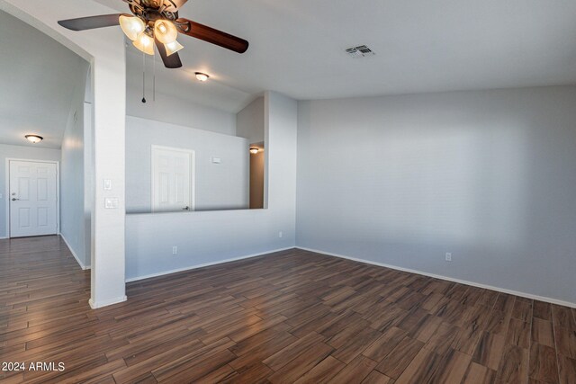 spare room with lofted ceiling, ceiling fan, and dark hardwood / wood-style flooring