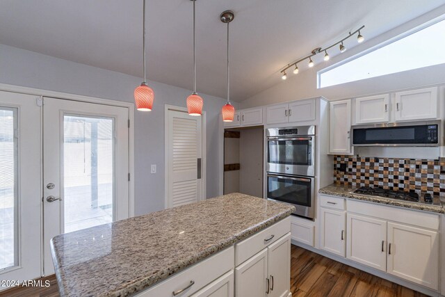 kitchen featuring lofted ceiling, white cabinets, and stainless steel appliances