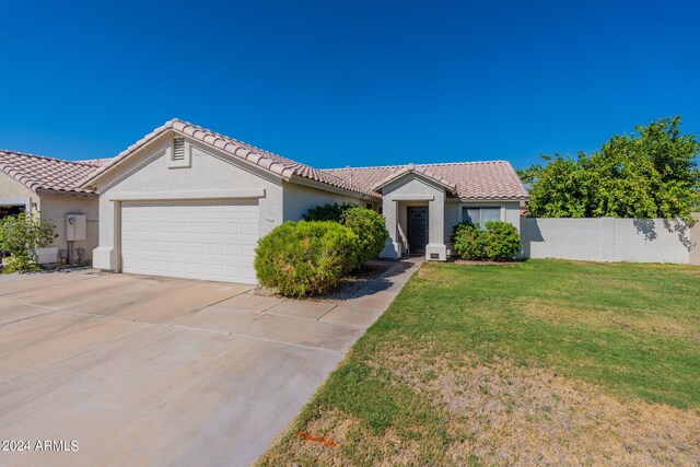 view of front of home featuring a garage and a front lawn