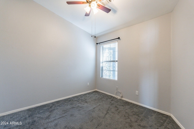 carpeted empty room featuring vaulted ceiling and ceiling fan