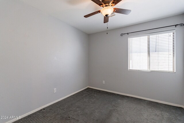 unfurnished room with ceiling fan and carpet