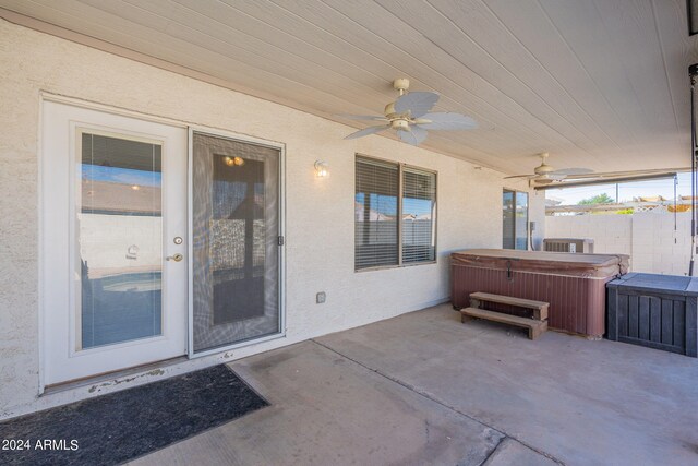 view of patio featuring a hot tub and ceiling fan