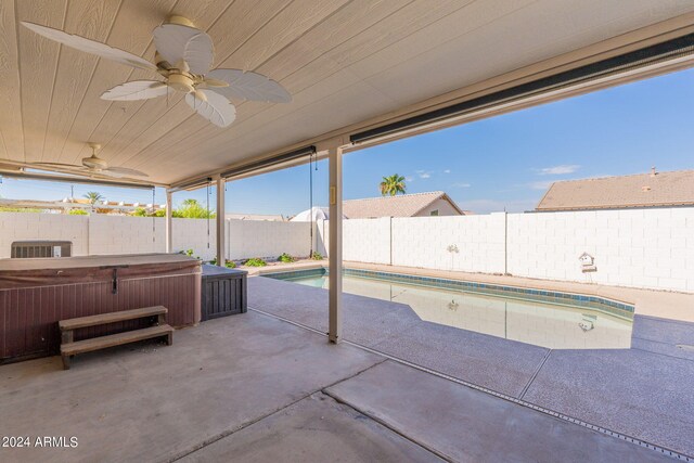 view of patio / terrace with ceiling fan, central air condition unit, and a swimming pool with hot tub