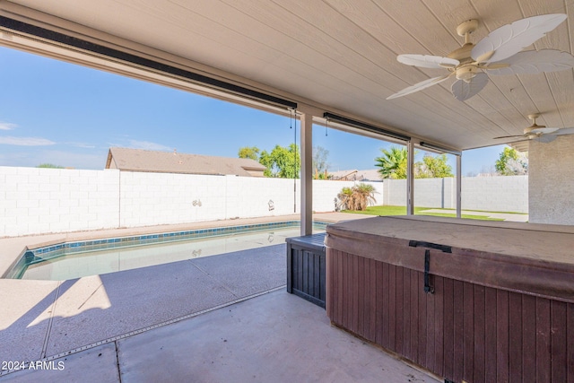 view of patio / terrace with a swimming pool with hot tub and ceiling fan