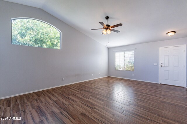 spare room with lofted ceiling, ceiling fan, and dark hardwood / wood-style floors