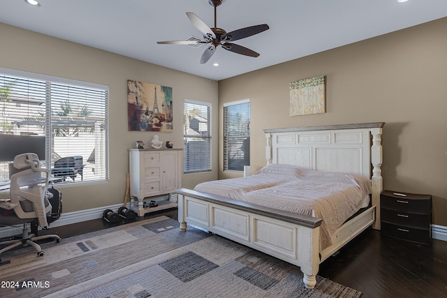 bedroom with dark hardwood / wood-style floors and ceiling fan