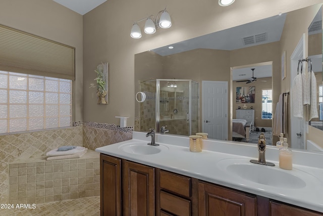 bathroom featuring ceiling fan, an enclosed shower, tile walls, and vanity