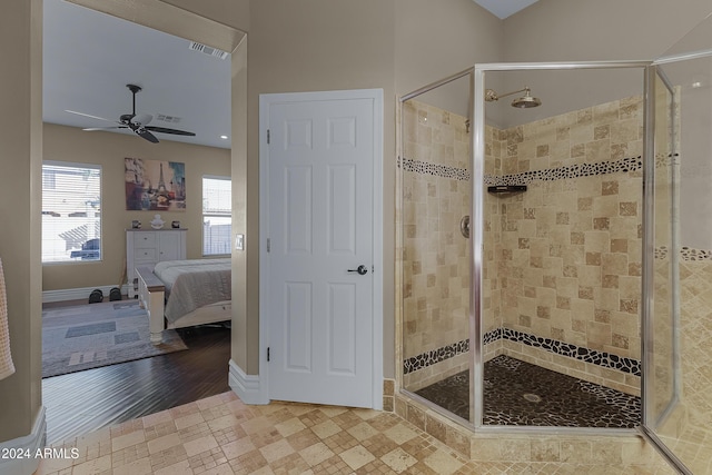 bathroom with wood-type flooring, a shower with door, and ceiling fan