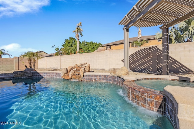 view of swimming pool featuring pool water feature, a pergola, and an in ground hot tub