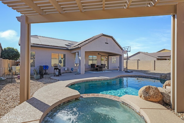 view of pool with an in ground hot tub, ceiling fan, and a patio