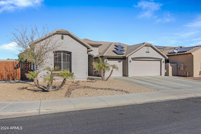 view of front facade with solar panels and a garage