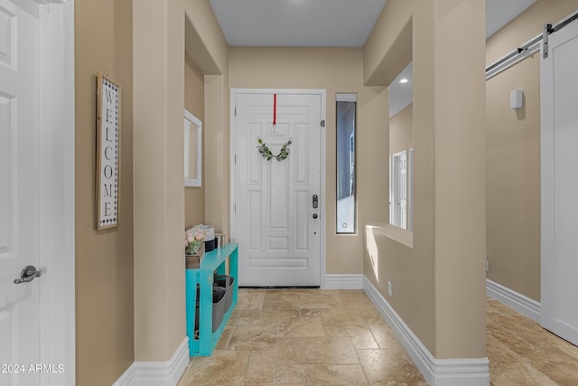 entrance foyer with a barn door