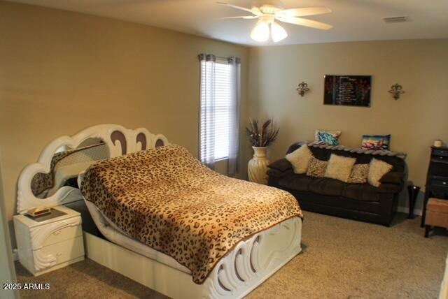 carpeted bedroom with ceiling fan and visible vents