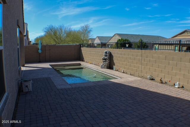 view of swimming pool featuring a patio area, a fenced backyard, and a fenced in pool