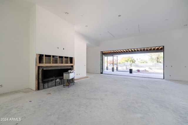 unfurnished living room with a high ceiling