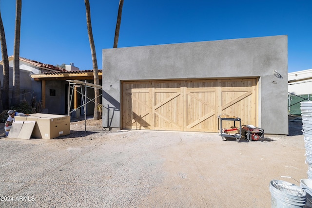 back of house with a garage