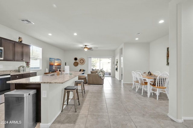 4714 W Nutmeg Ave, Coolidge, AZ 85128 - kitchen with stove, healthy amount of natural light, ceiling fan, a kitchen island with sink, and recessed lighting