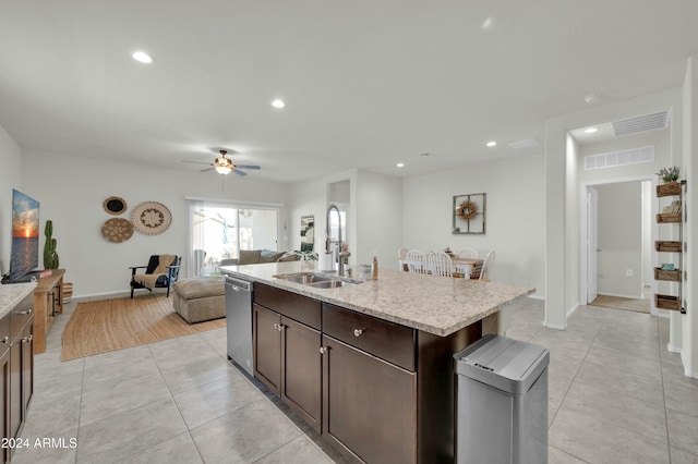 kitchen featuring dishwasher, sink, ceiling fan, an island with sink, and dark brown cabinetry