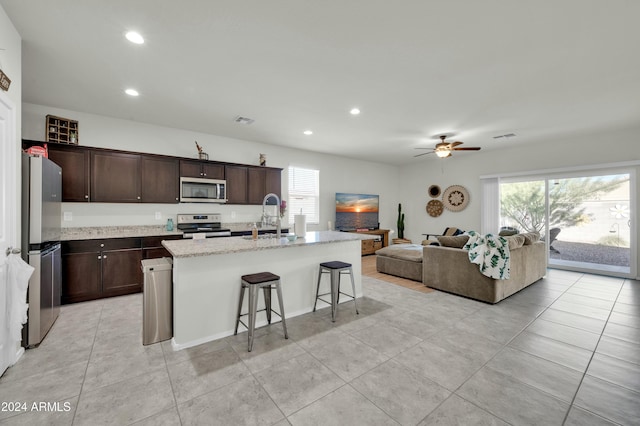 4714 W Nutmeg Ave, Coolidge, AZ 85128 - kitchen featuring appliances with stainless steel finishes, open floor plan, healthy amount of natural light, a ceiling fan, and recessed lighting