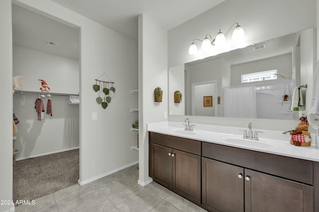 4714 W Nutmeg Ave, Coolidge, AZ 85128 - full bathroom with double vanity, a walk in closet, and tile patterned floors