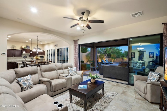 8733 E Jacaranda St, Mesa, AZ 85207 - living room with visible vents, recessed lighting, arched walkways, and ceiling fan with notable chandelier