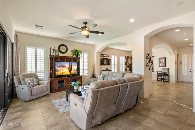 8733 E Jacaranda St, Mesa, AZ 85207 - living room featuring visible vents, light tile patterned floors, arched walkways, a ceiling fan, and recessed lighting