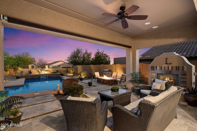 8733 E Jacaranda St, Mesa, AZ 85207 - patio terrace at dusk featuring a fenced in pool, grilling area, a fenced backyard, and an outdoor living space with a fireplace
