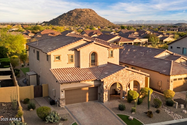 8733 E Jacaranda St, Mesa, AZ 85207 - mediterranean / spanish-style house featuring a mountain view, a tile roof, a gate, and decorative driveway