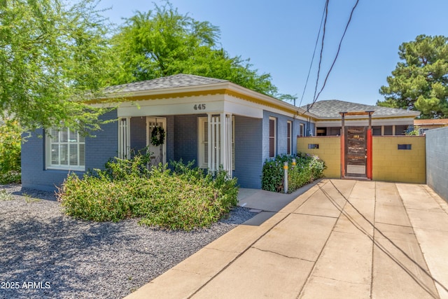 445 W 1st St, Mesa, AZ 85202 - view of front of property featuring brick siding, a gate, and a shingled roof