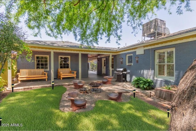 445 W 1st St, Mesa, AZ 85202 - back of house with a fire pit, a patio area, a lawn, and brick siding