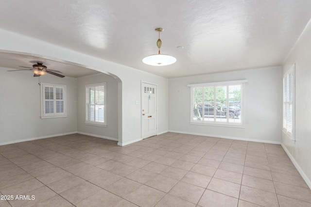 445 W 1st St, Mesa, AZ 85202 - empty room featuring light tile patterned floors, plenty of natural light, and arched walkways