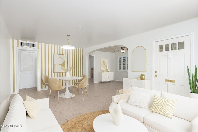 445 W 1st St, Mesa, AZ 85202 - living room featuring arched walkways, ceiling fan, and light tile patterned floors