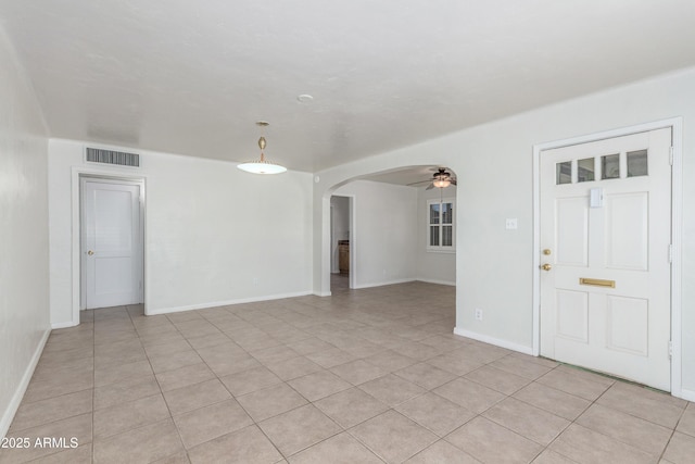 445 W 1st St, Mesa, AZ 85202 - unfurnished room featuring arched walkways, light tile patterned floors, and a ceiling fan