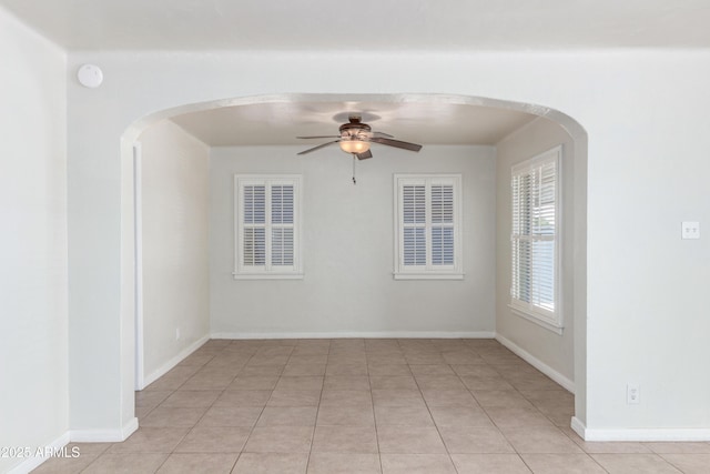 445 W 1st St, Mesa, AZ 85202 - spare room featuring ceiling fan, arched walkways, and light tile patterned flooring