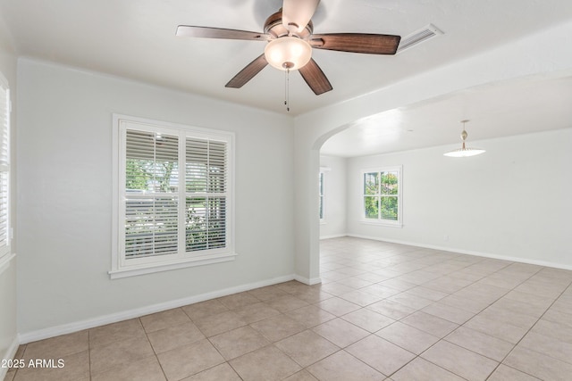 445 W 1st St, Mesa, AZ 85202 - unfurnished room featuring arched walkways, light tile patterned floors, and a ceiling fan