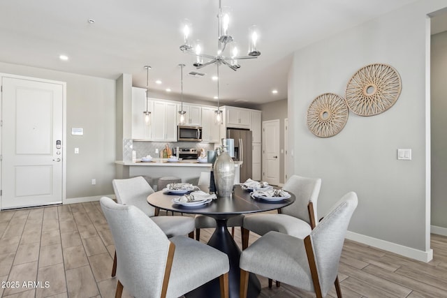 dining space featuring a chandelier, recessed lighting, visible vents, baseboards, and wood tiled floor