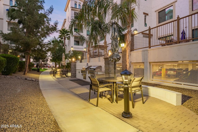 patio terrace at dusk featuring exterior kitchen