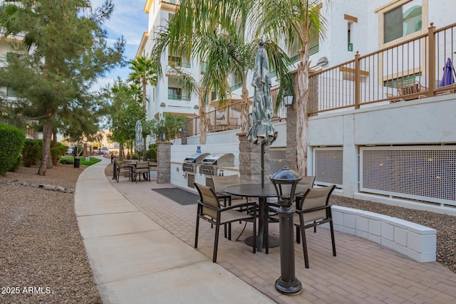 view of patio with a grill, outdoor dining area, and area for grilling