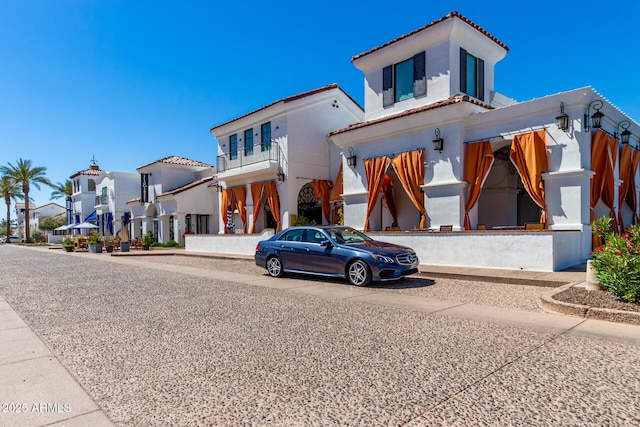 view of front of home with a tile roof and a residential view