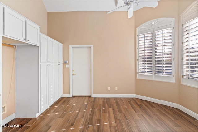 spare room featuring dark wood-type flooring and ceiling fan