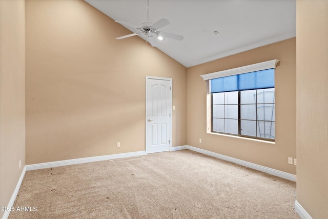 carpeted spare room with ceiling fan and lofted ceiling