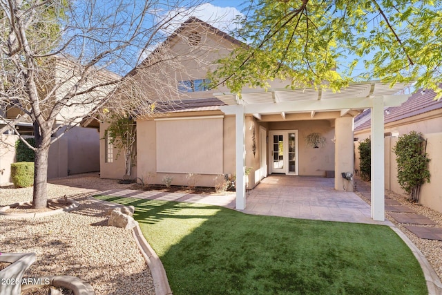 back of property with a lawn, a patio, and a pergola