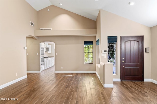 entrance foyer featuring high vaulted ceiling