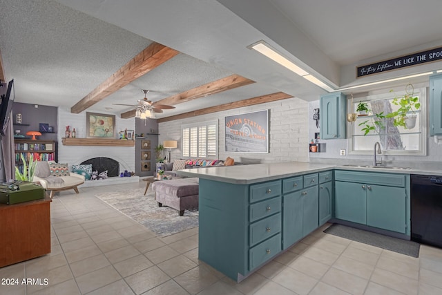 kitchen featuring a healthy amount of sunlight, kitchen peninsula, a fireplace, and dishwasher