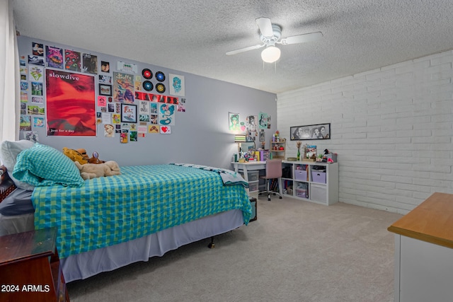 carpeted bedroom featuring a textured ceiling, ceiling fan, and brick wall