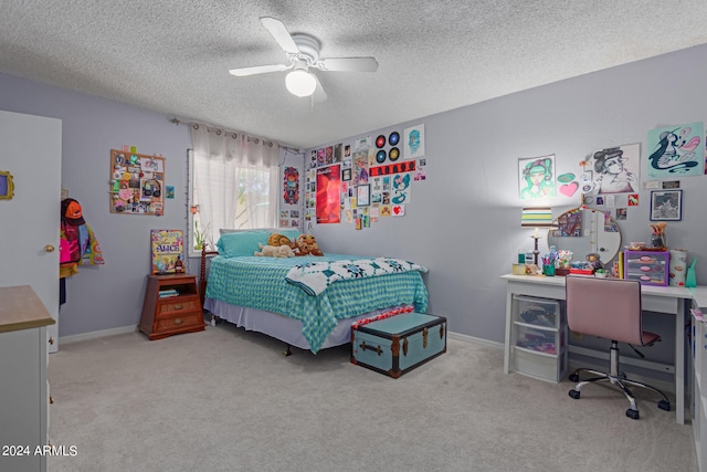 bedroom featuring a textured ceiling, ceiling fan, and light colored carpet